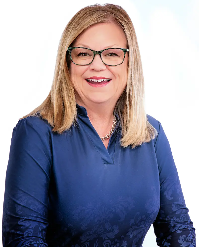 Pam smiling and posing for a picture